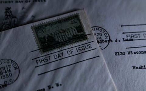 A close-up of a vintage first day of issue postage stamp on an envelope, evoking nostalgia.