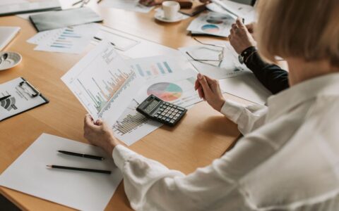 Business team analyzing financial data and graphs during a meeting to strategize growth.
